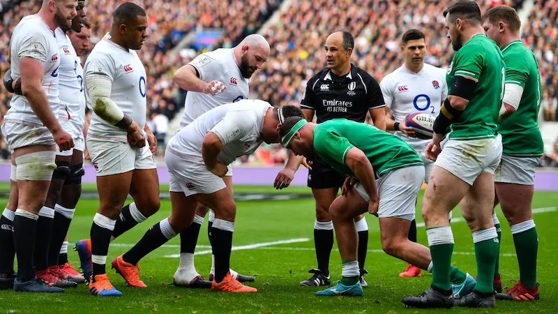 front row players starting to assemble for a scrum with hookers showing a good brake foot